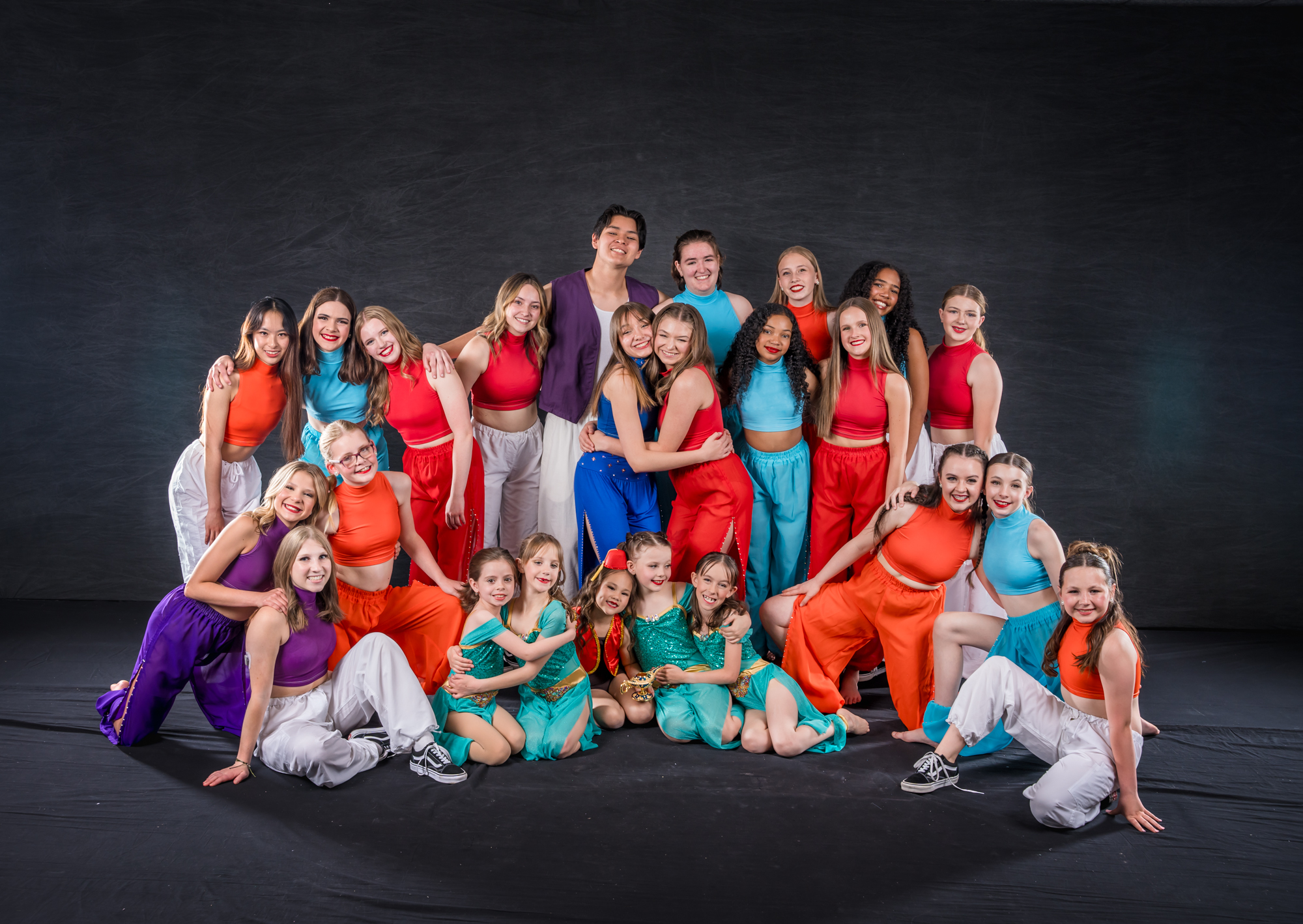 All That Dance students posing in bright performance costumes